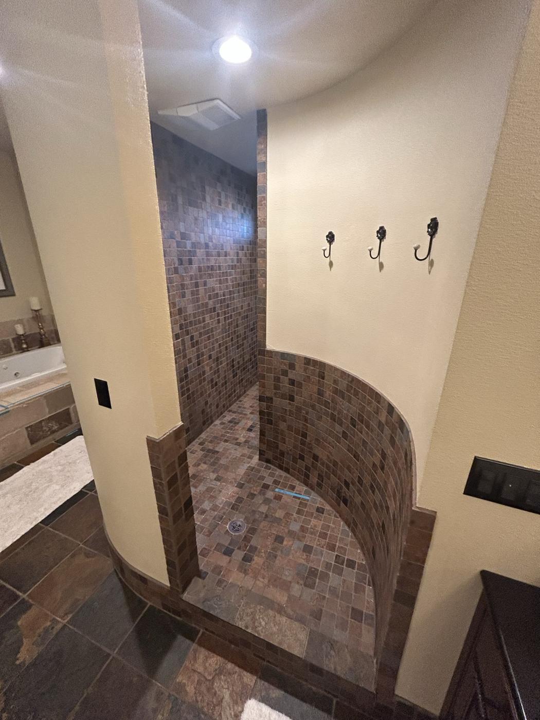 Original curved shower with dated tile
