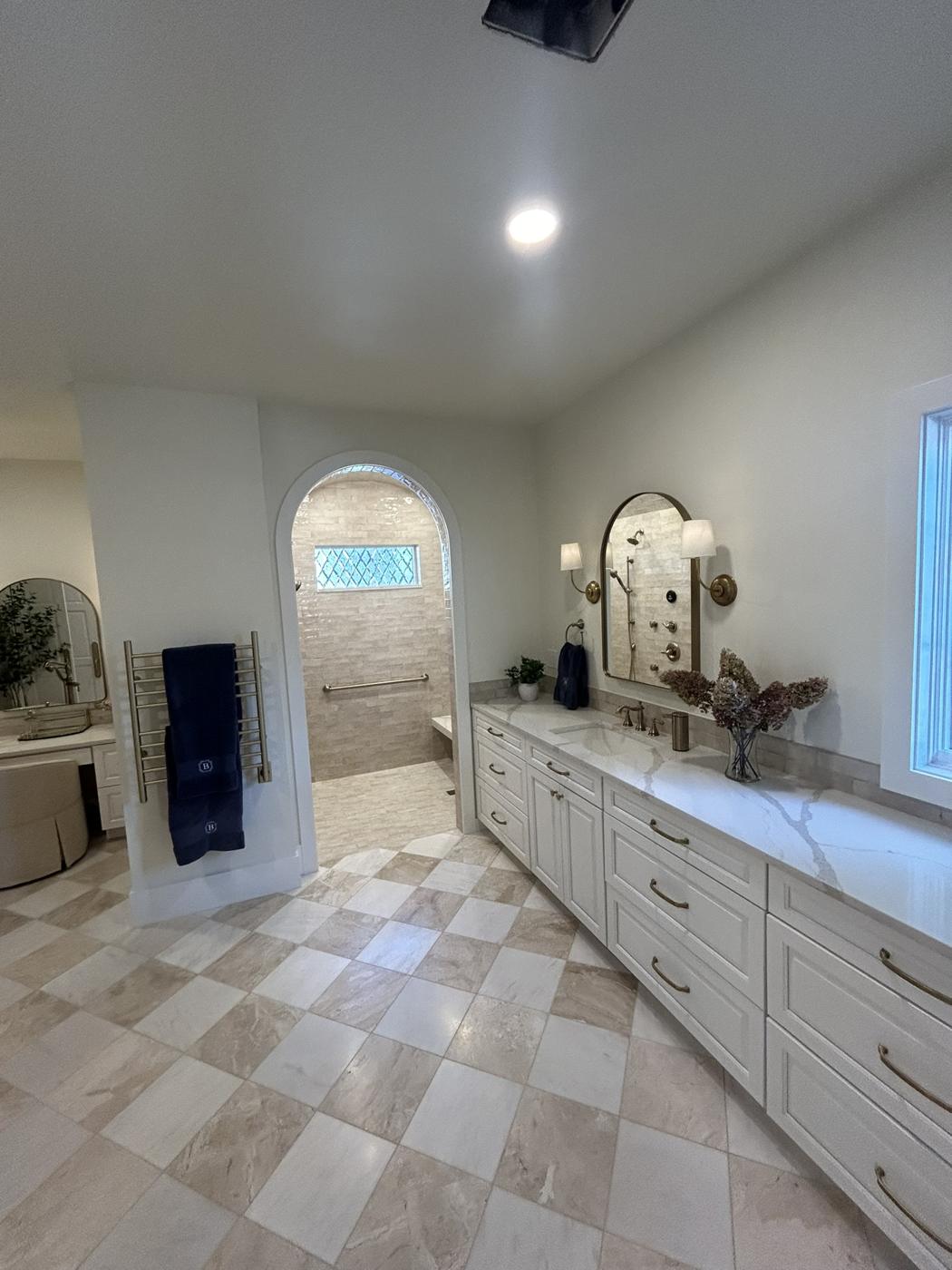 White double vanity with diamond-pattern stone floor