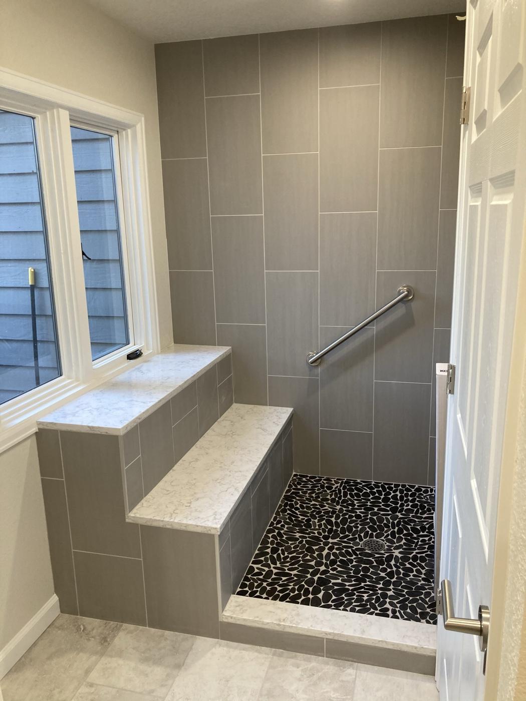 Walk-in shower with built-in bench and full tile surround