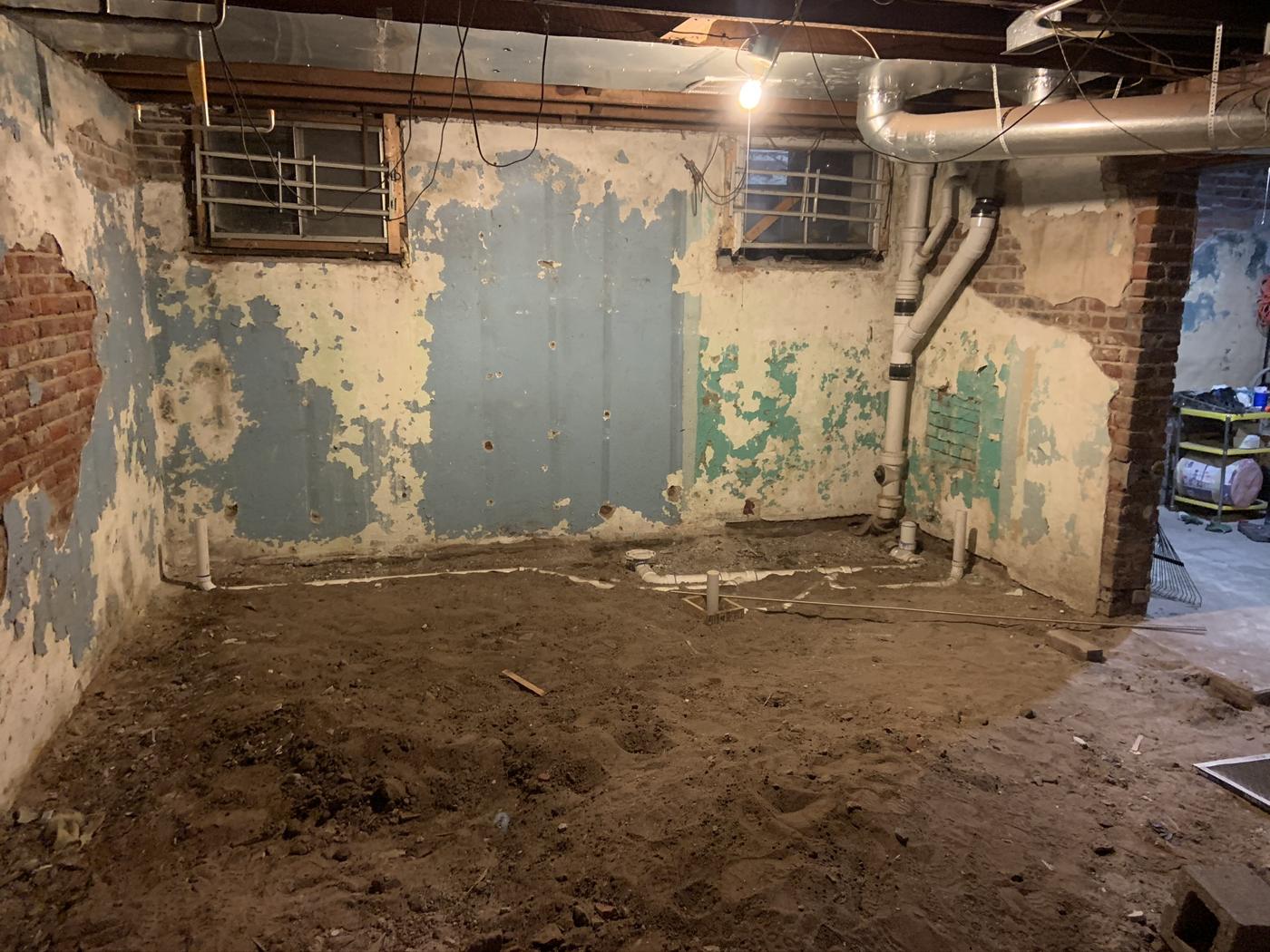 Dirt basement floor before
