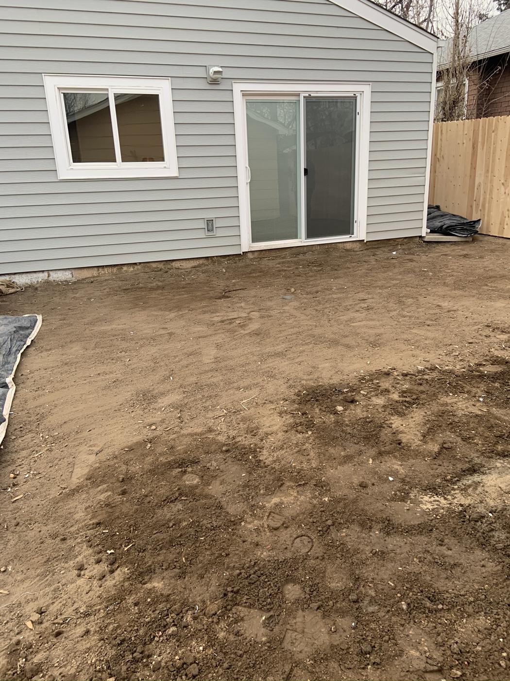 Bare dirt yard before the patio