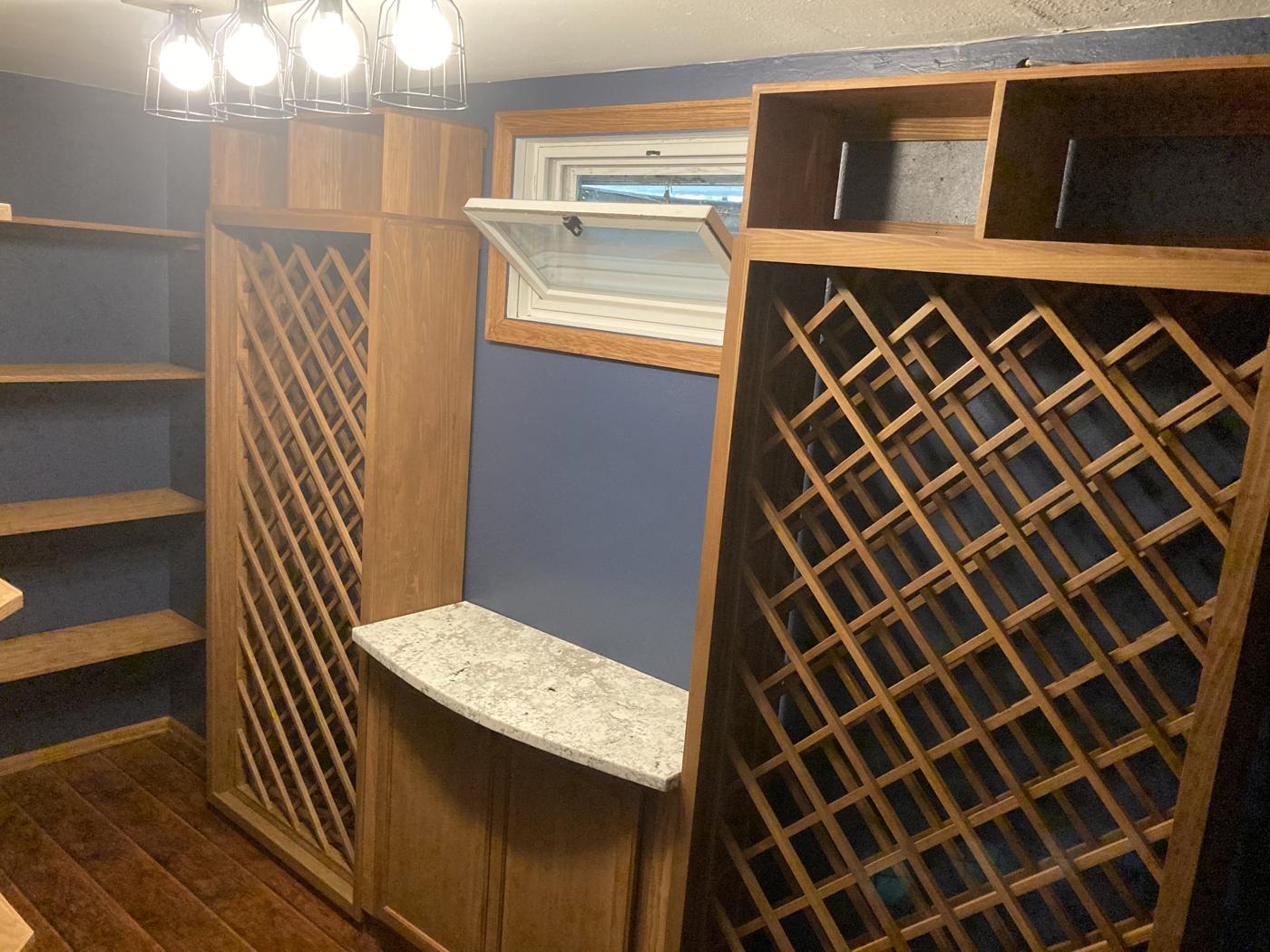 Finished wine cellar with built-in wood shelving and diamond wine racks